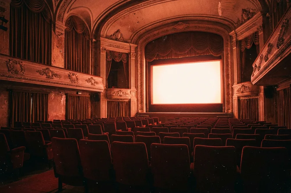 An empty cinema lit by the screen